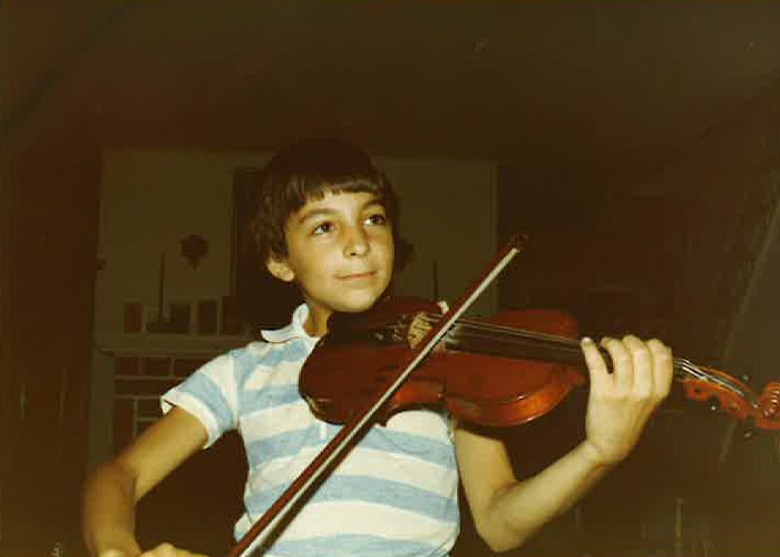 Young Richard with a violin in an undated archival color photograph