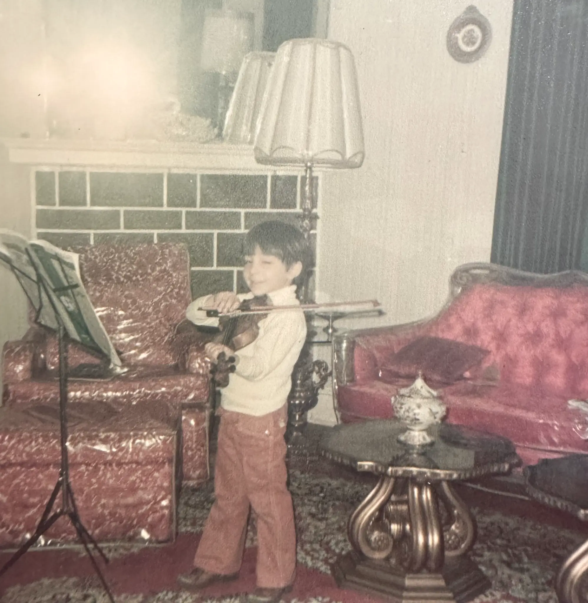 Richard playing violin at age four