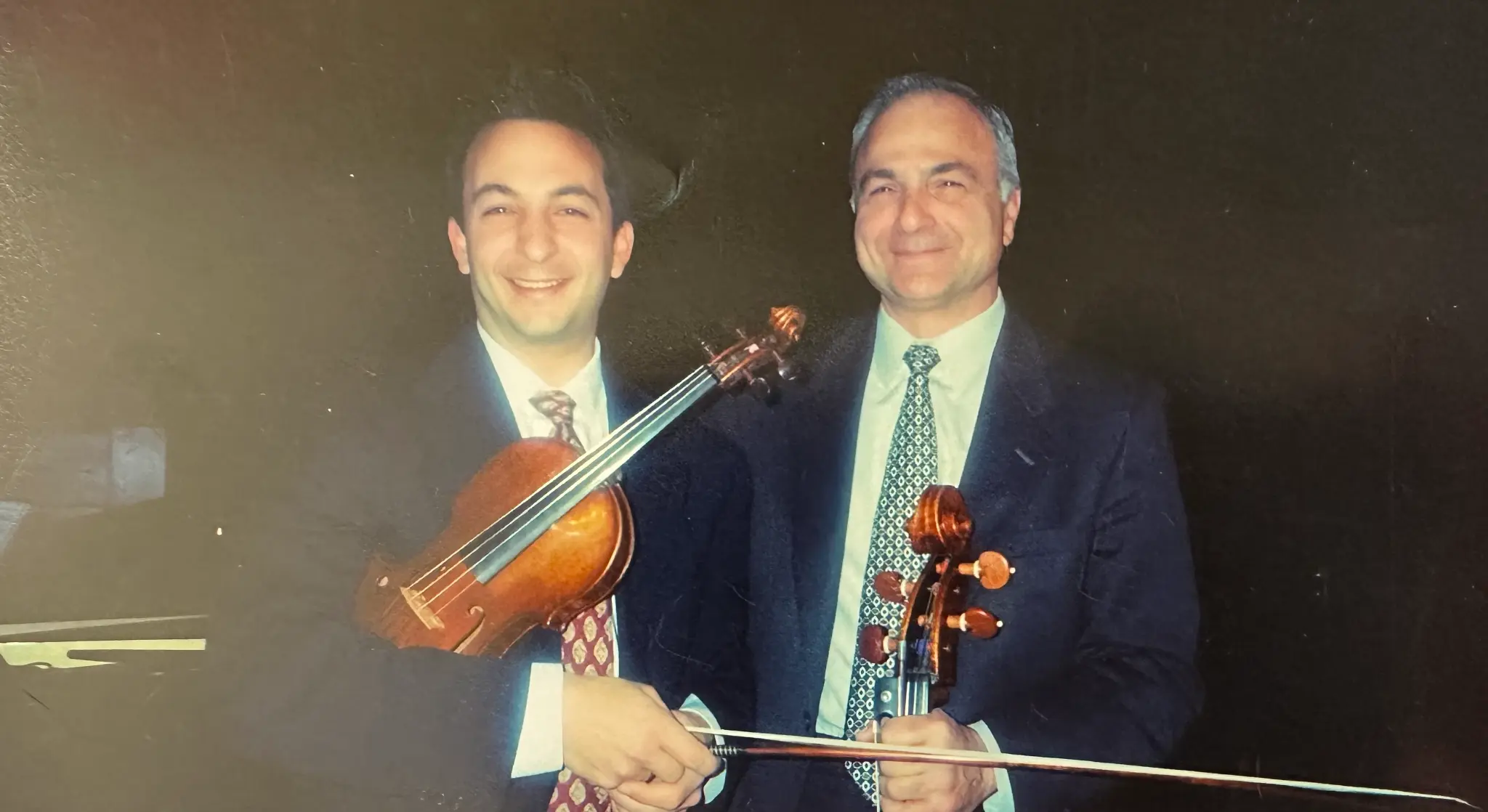 Richard and his father holding their instruments