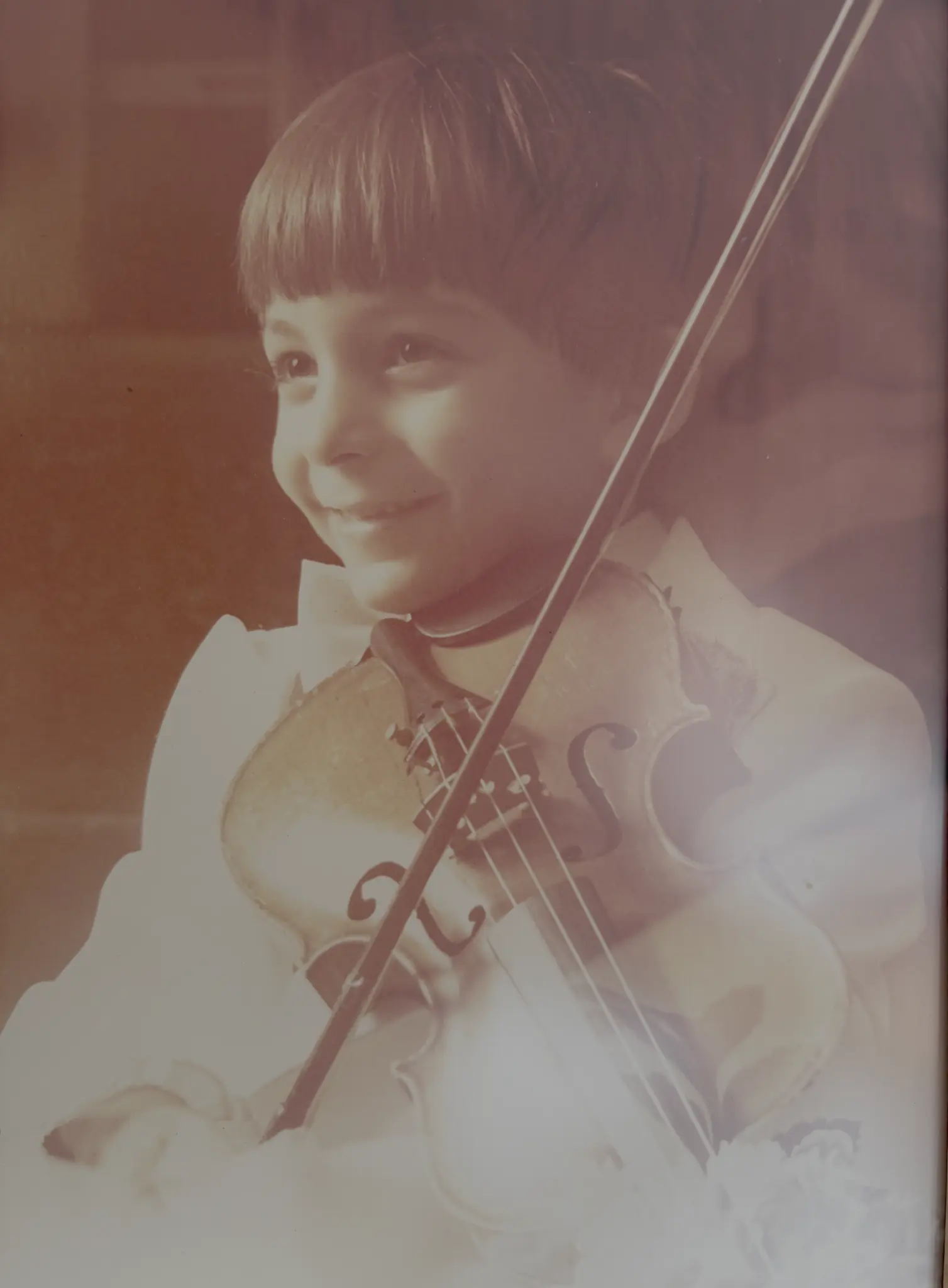 Richard playing violin at his aunt’s wedding at age five